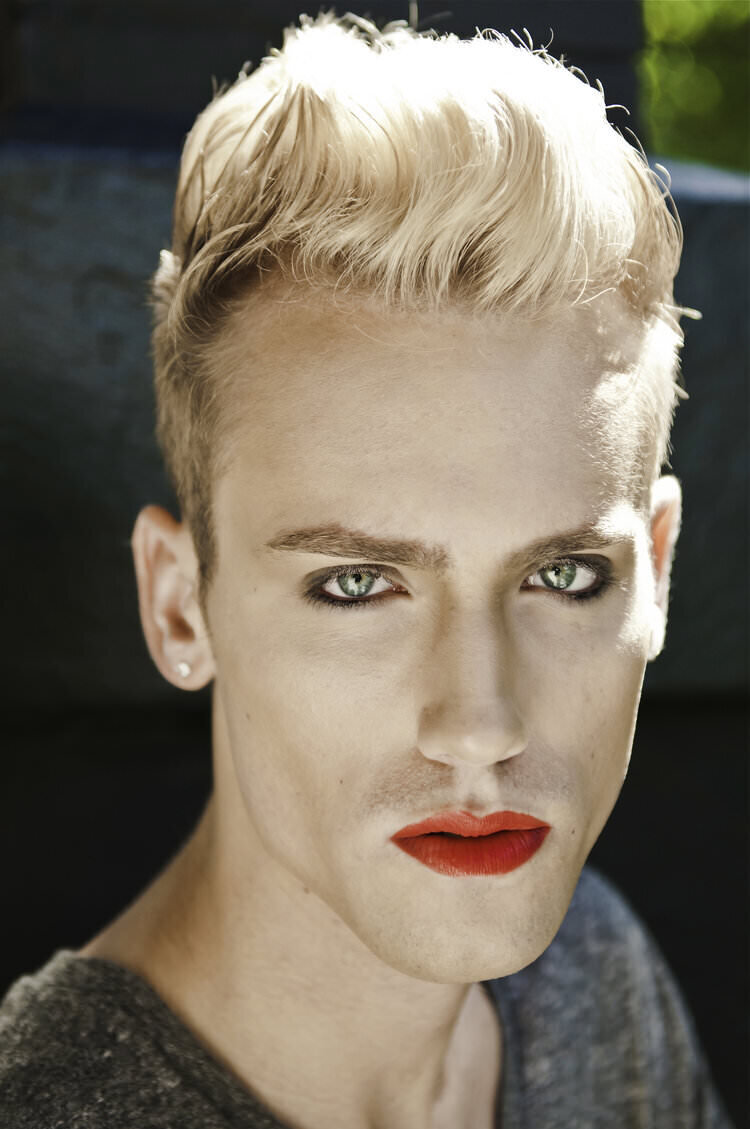 A person in makeup looking straight forward