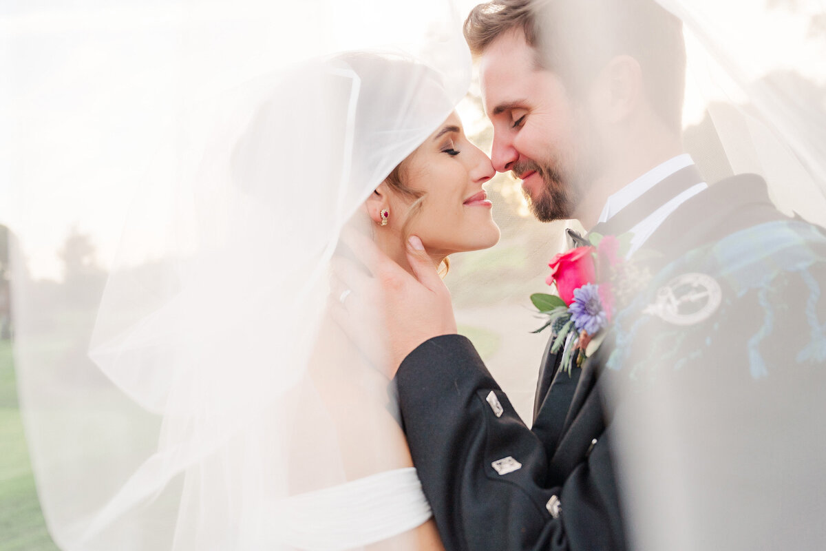 bride and groom under veil at lke club ohio wedding
