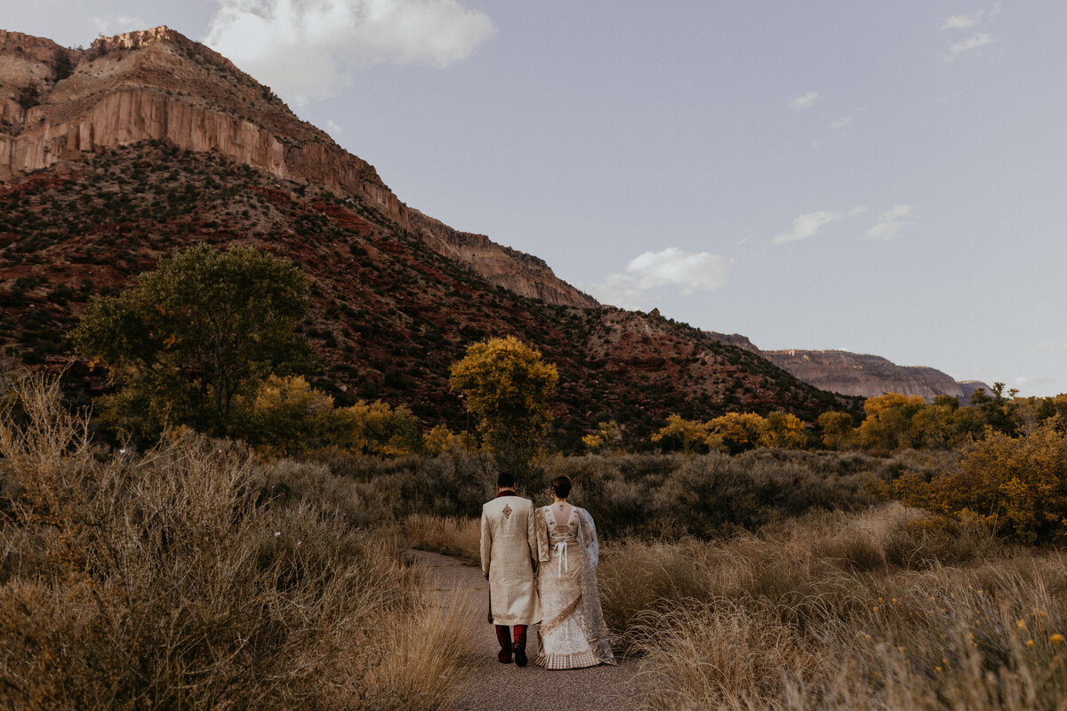 Indian newlyweds walking along the red rocks in Jemez Springs, New Mexico