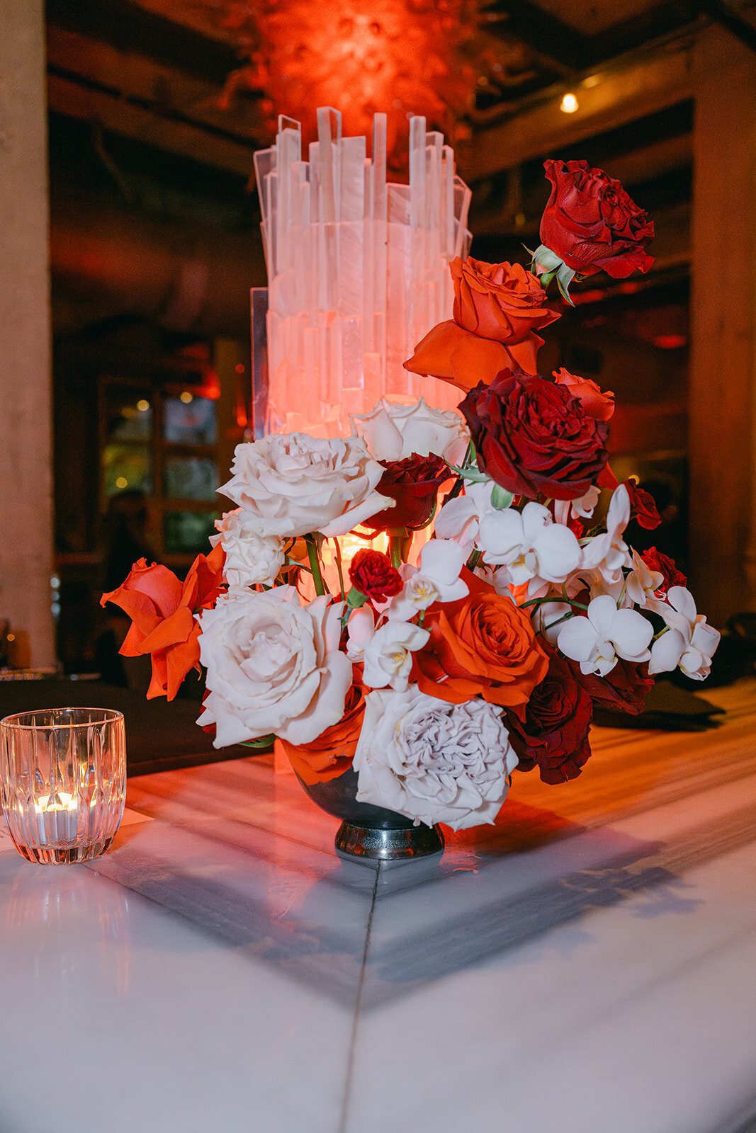 Lush roses and white orchids in bold centerpiece at San Antonio wedding venue reception