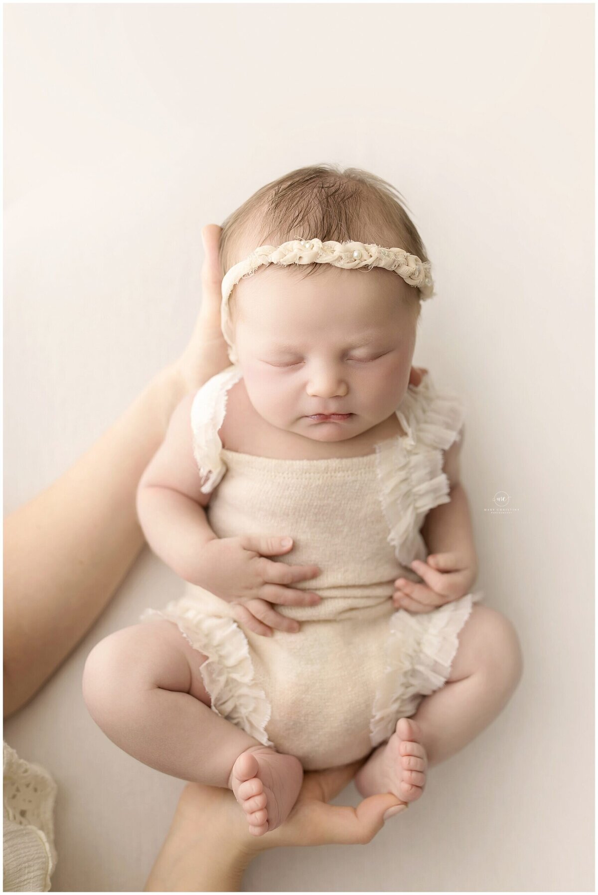 a peaceful newborn baby sleeping  through their portrait session in a Medina studio