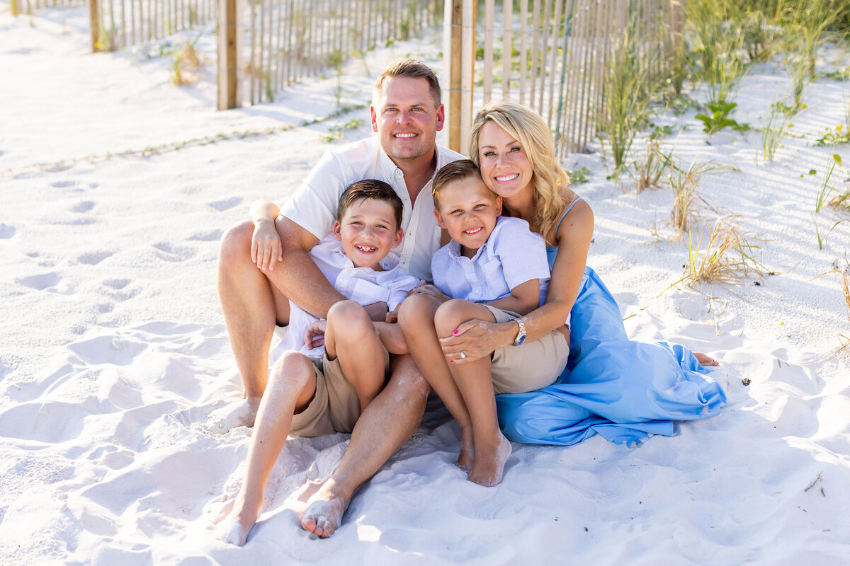 Family of four enjoying a beach photoshoot in Seacrest Beach, Florida at High Pointe by 30A photographer Gwyne Gray.
