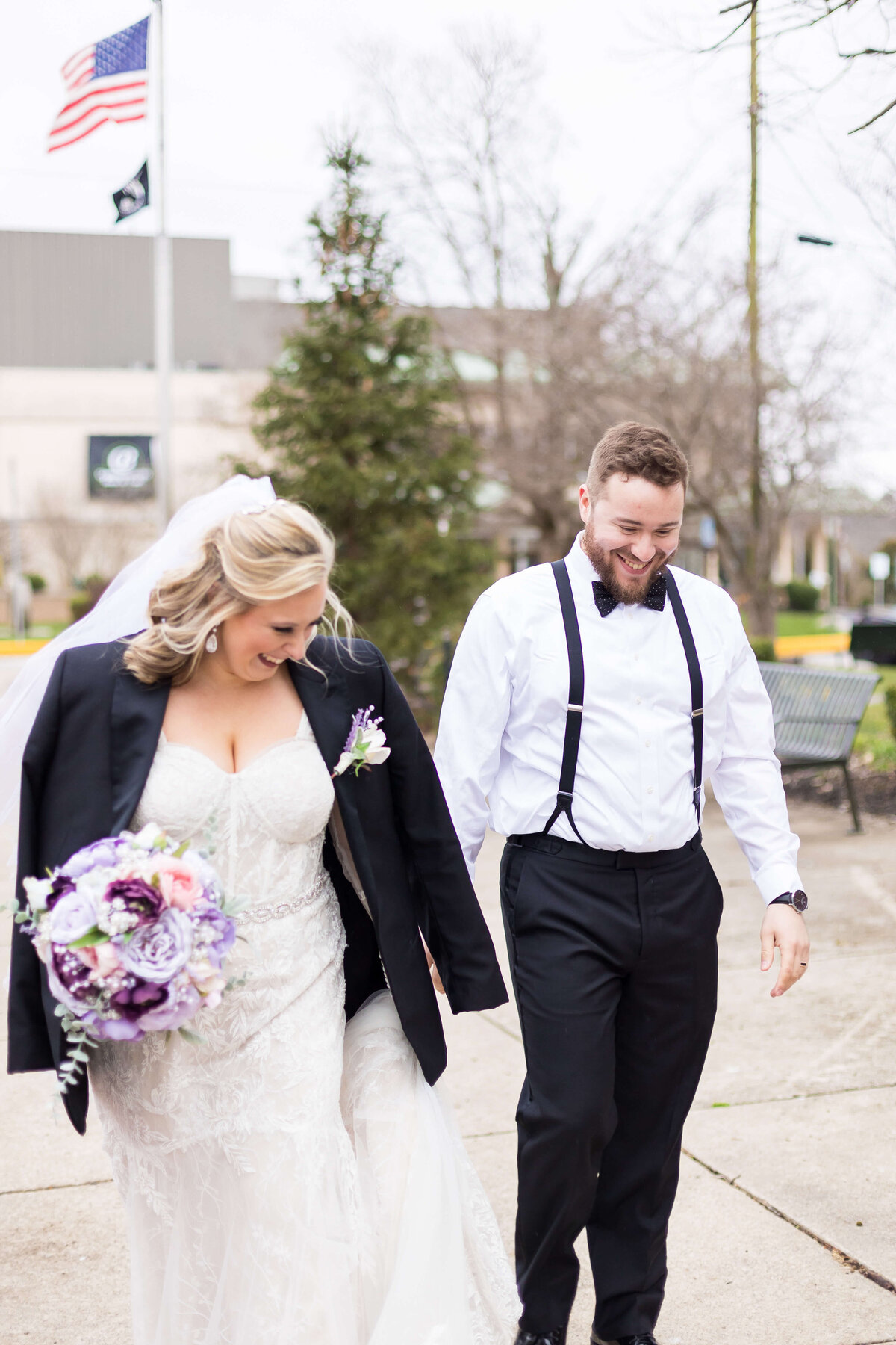 Bride with grooms suit over her shoulders at  The Gatsby in Shelbyville,KY