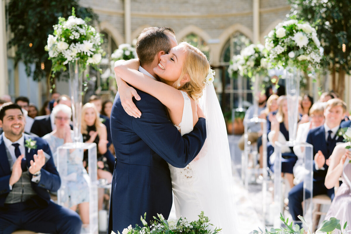 bride and groom hugging in the orangery at tortworth court hotel after getting married