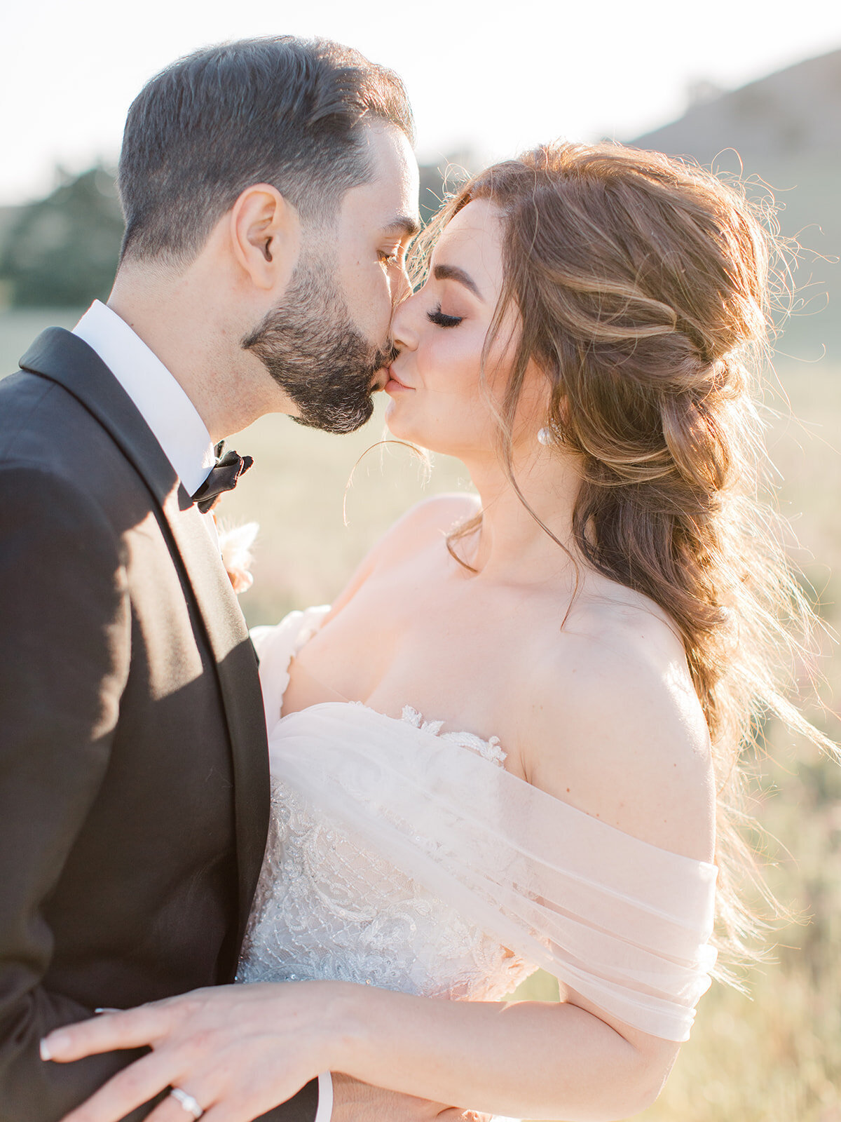 portrait of bride and groom kissing