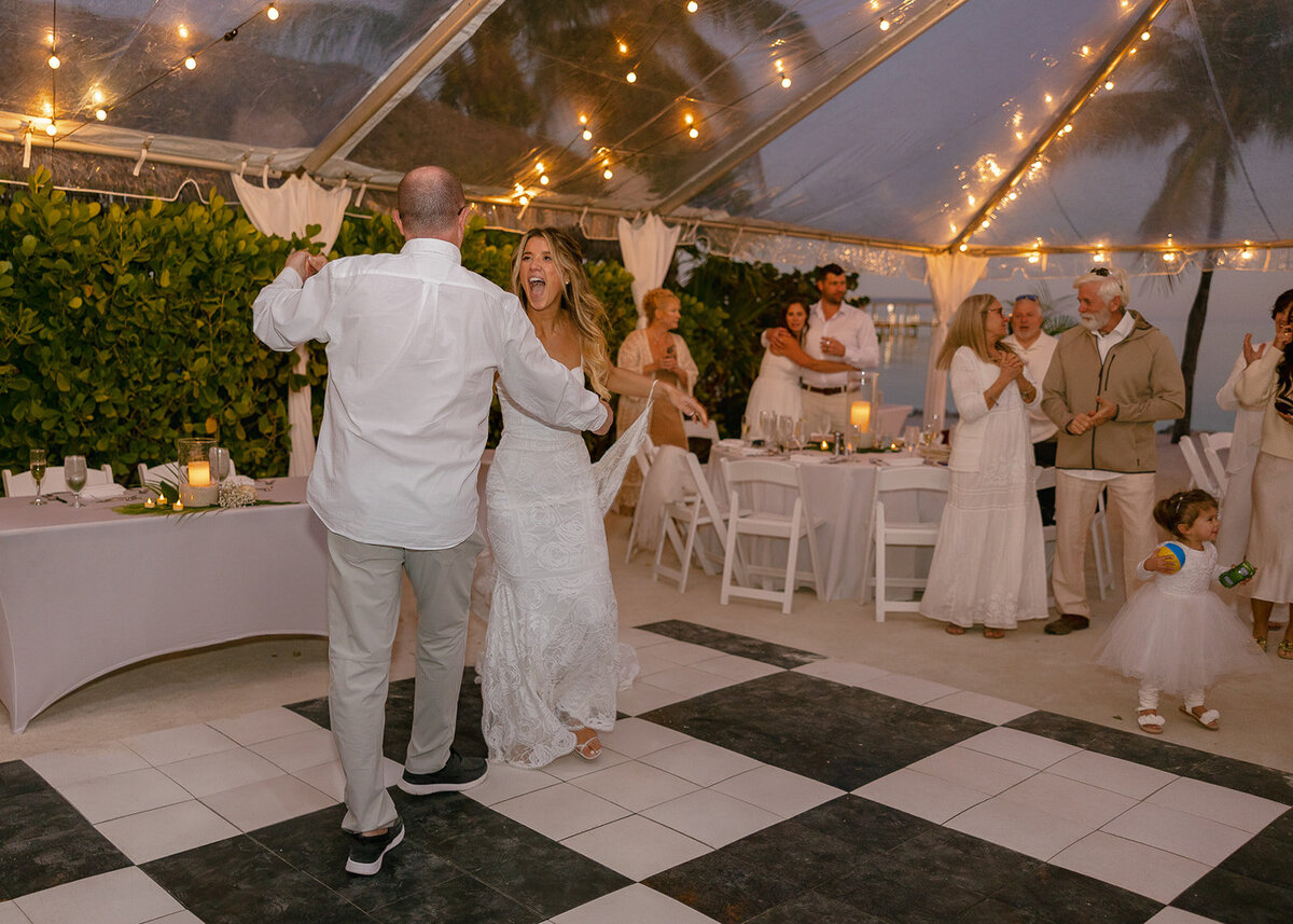 Laura and Abraham dancing under the lights at their wedding reception at Cheeca Lodge Resort.