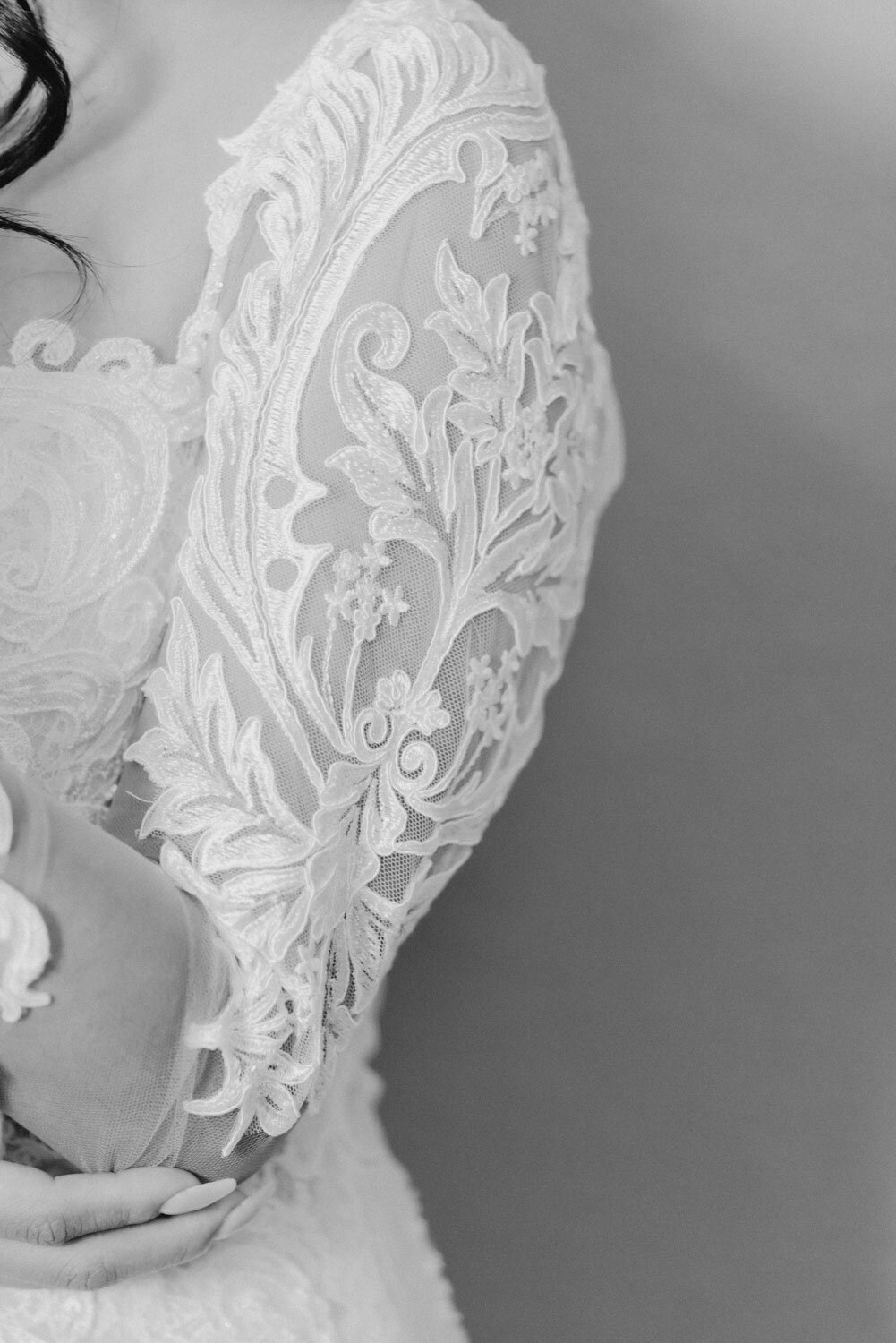 Close up black and white photo of a bride's arm