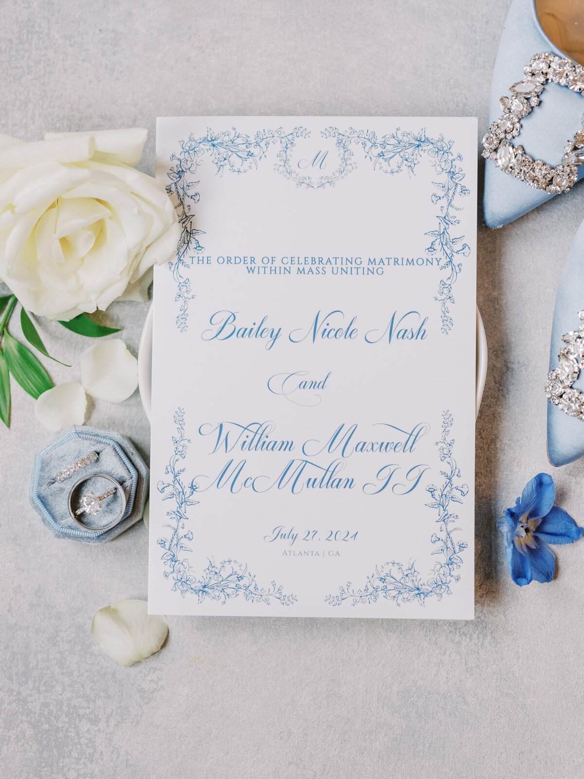Wedding Invitation with wedding rings and brides light blue shoes