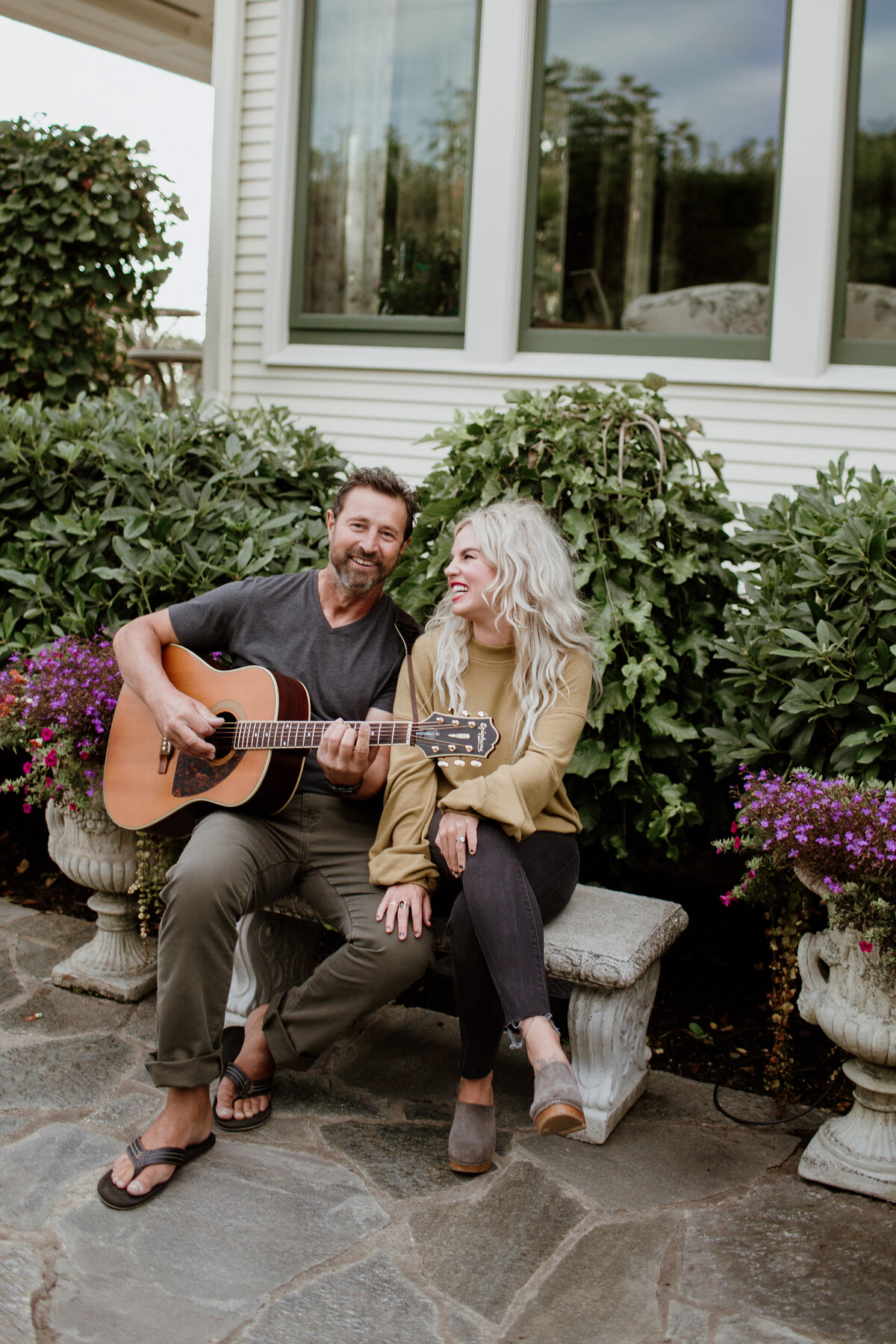 A couple sits and plays guitar during this engagement session captured by Fort Worth Wedding Photographer, Megan Christine Studio