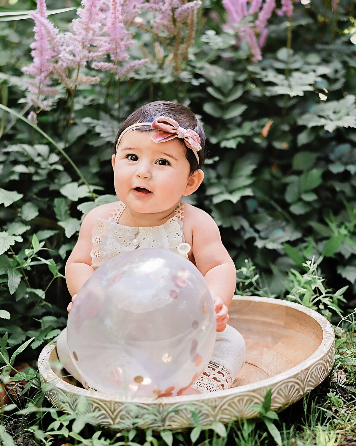 baby girl sitting in bowl with balloon in Portland garden