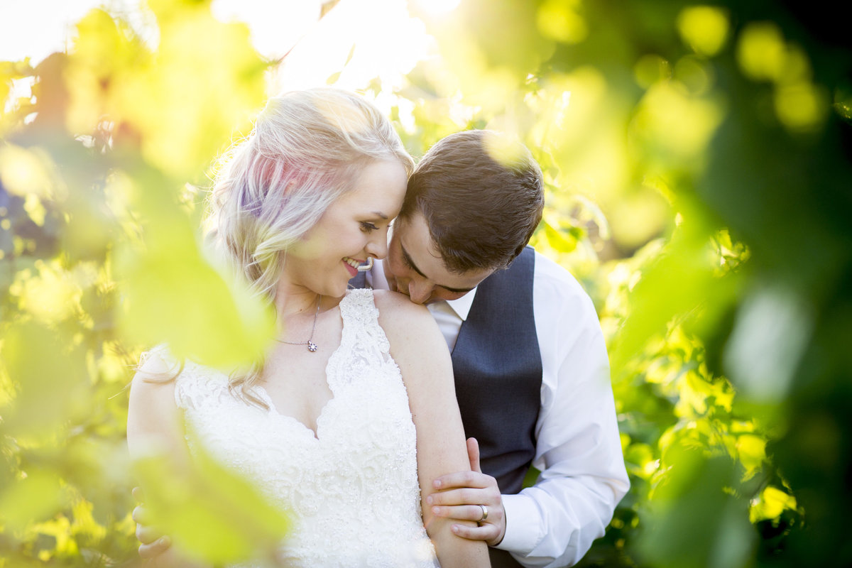 Oswego Hills Wedding Venue Oregon Vineyard Bride and Groom with Grapes