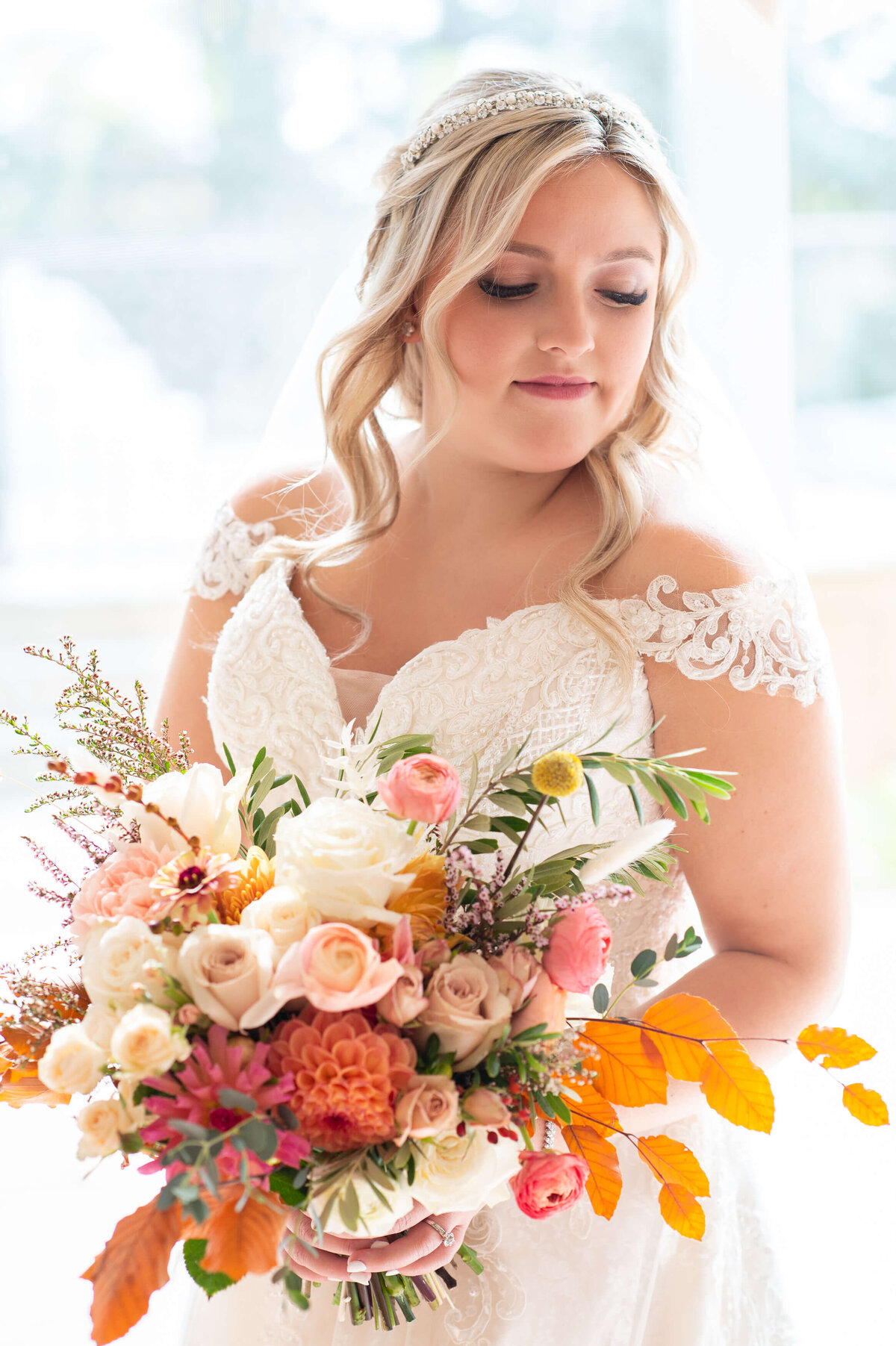 Ottawa wedding photos of a bride holding an orange bouquet taken by JEMMAN Photography