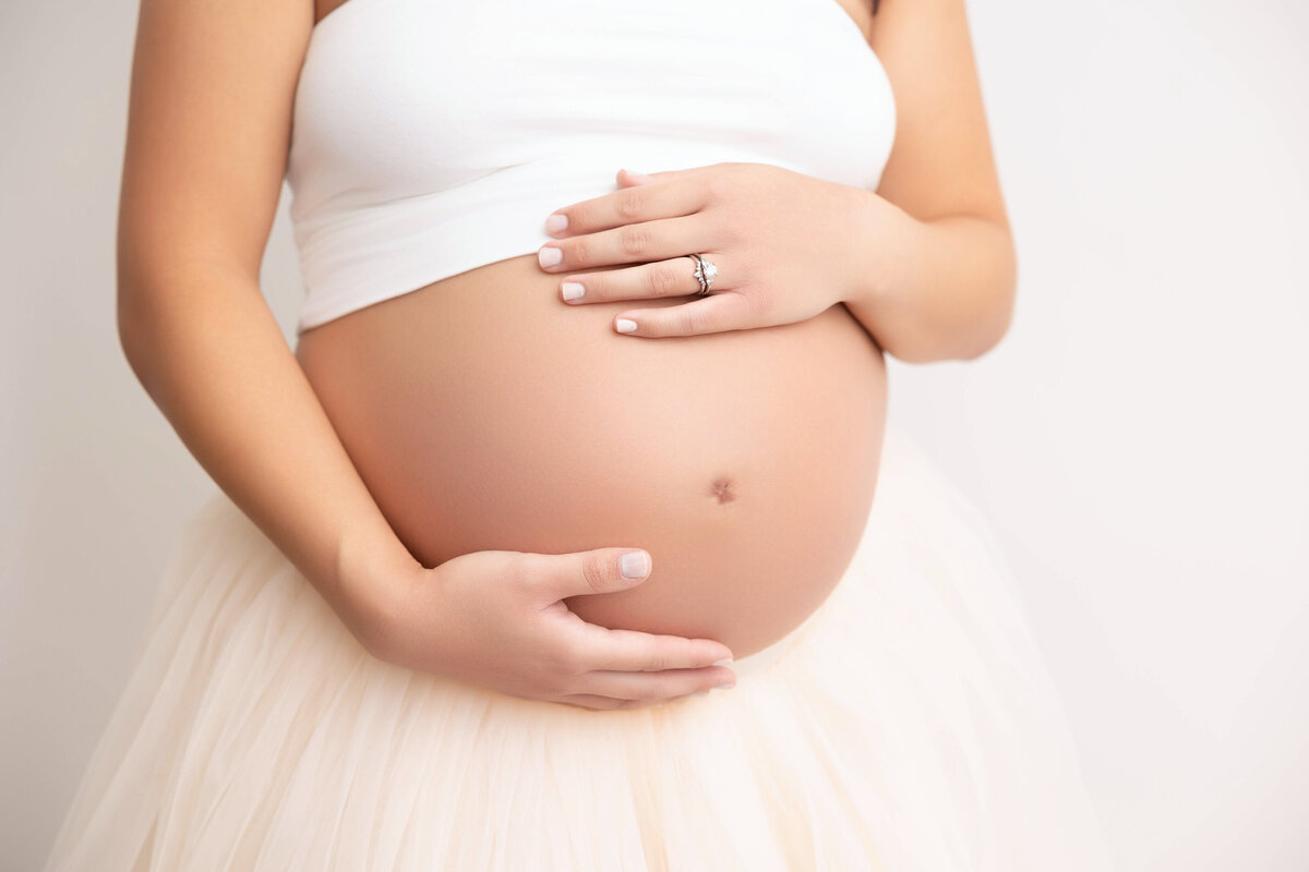 Close-up pregnant belly image showing bare skin.