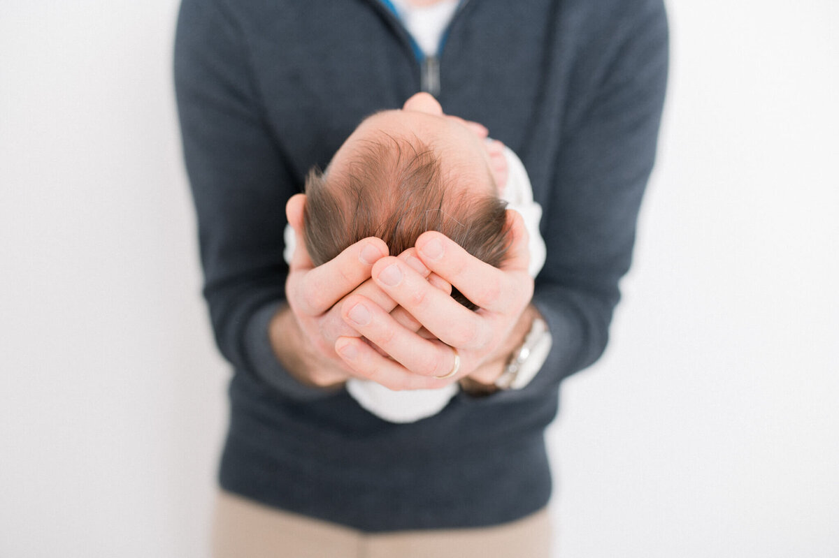 Niagara newborn photography of dad holding baby in arms
