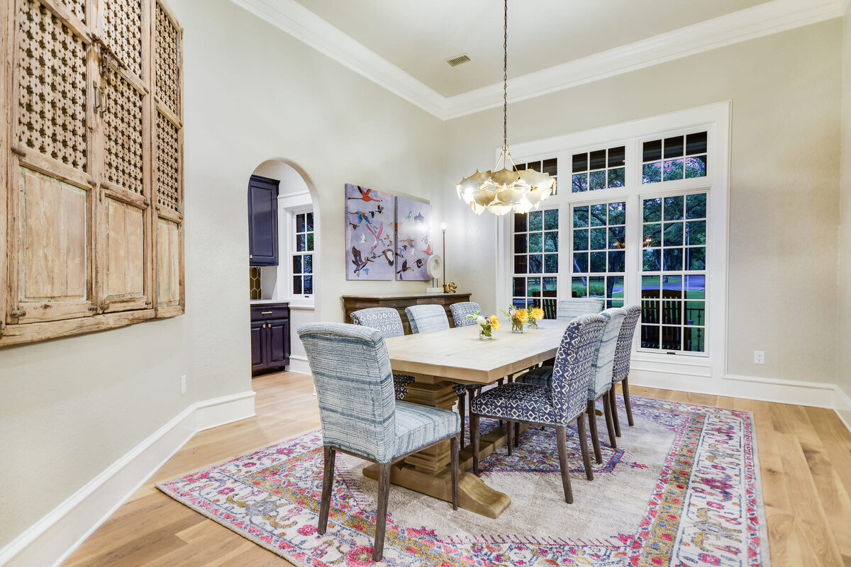 Luxury dining room with 8 seat dining table, bay window and hanging lamp above table