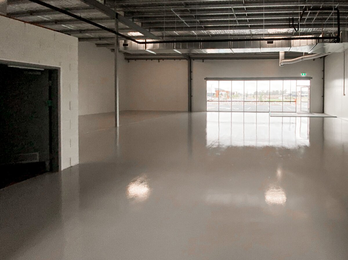 A large industrial warehouse with high grade and professional epoxy flooring.