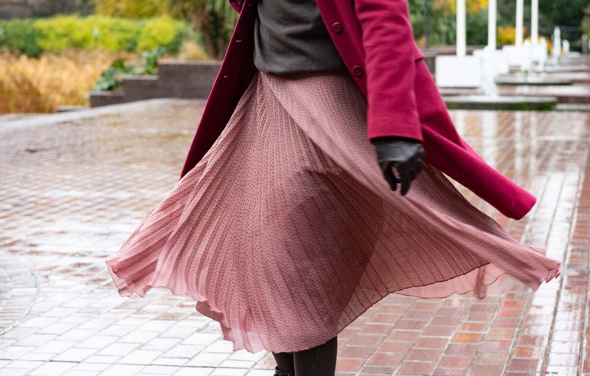 a women twirling in a pink floating skirt