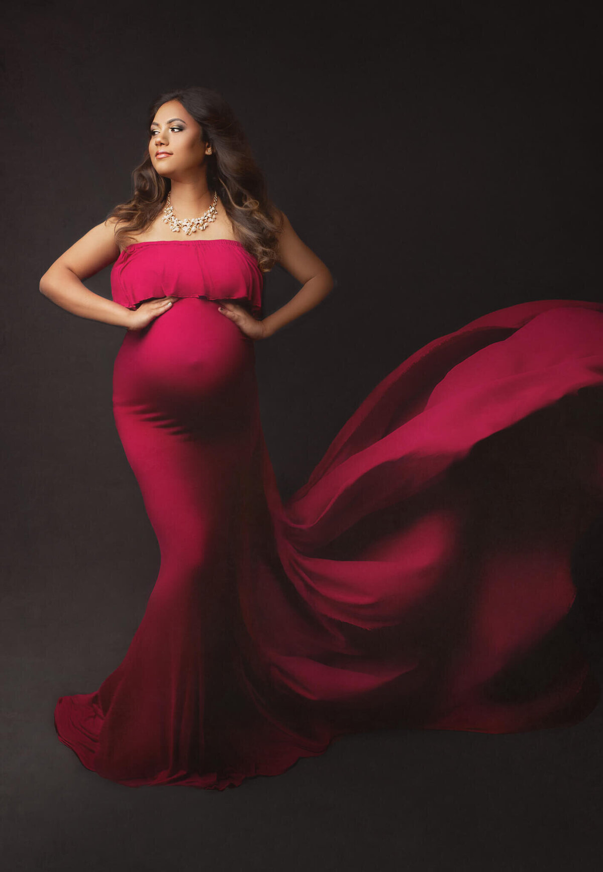 fine art maternity portrait with expecting mother in flowing red gown, hamilton maternity photographer