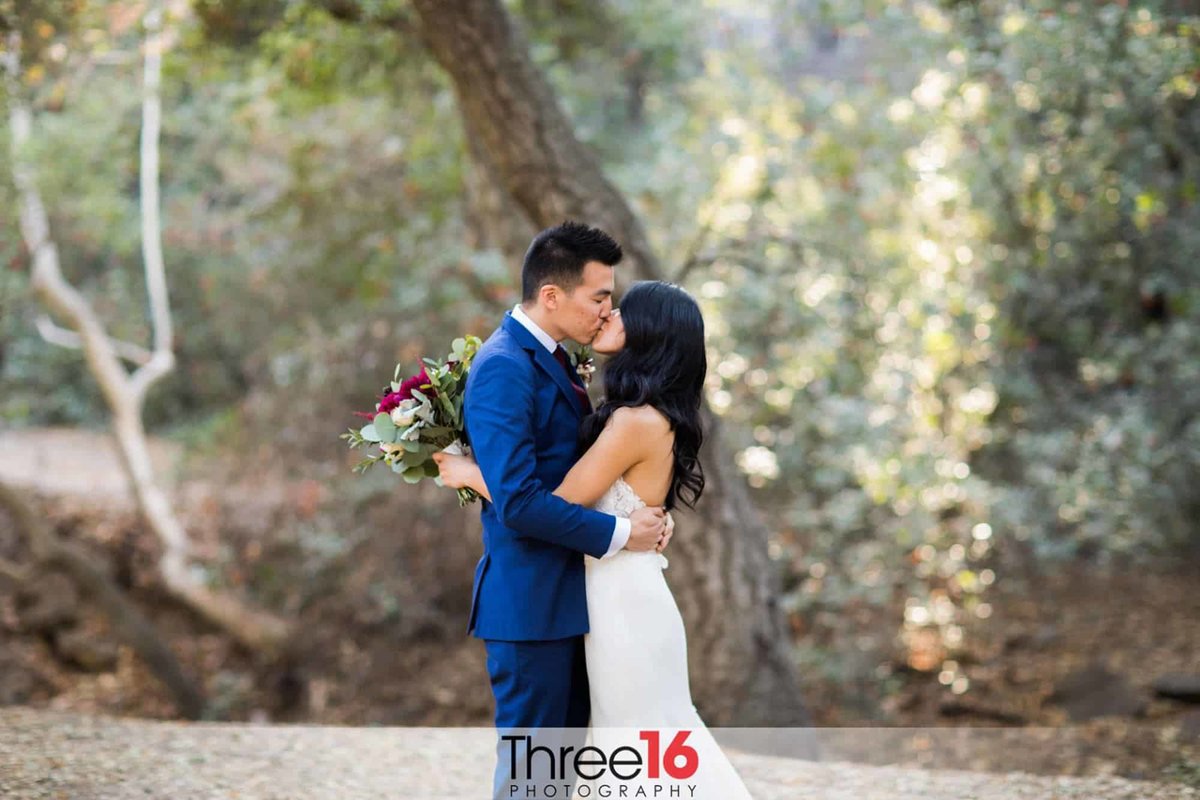 Sweet tender kiss between newly married couple at the Oak Canyon Nature Center