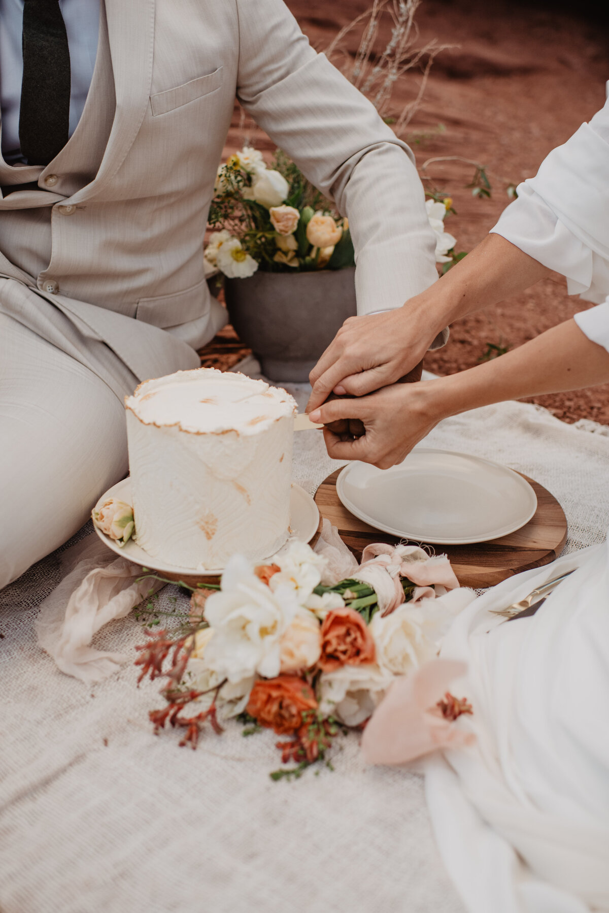 Utah Elopement Photographer captures couple cutting cake after intimate elopement ceremony