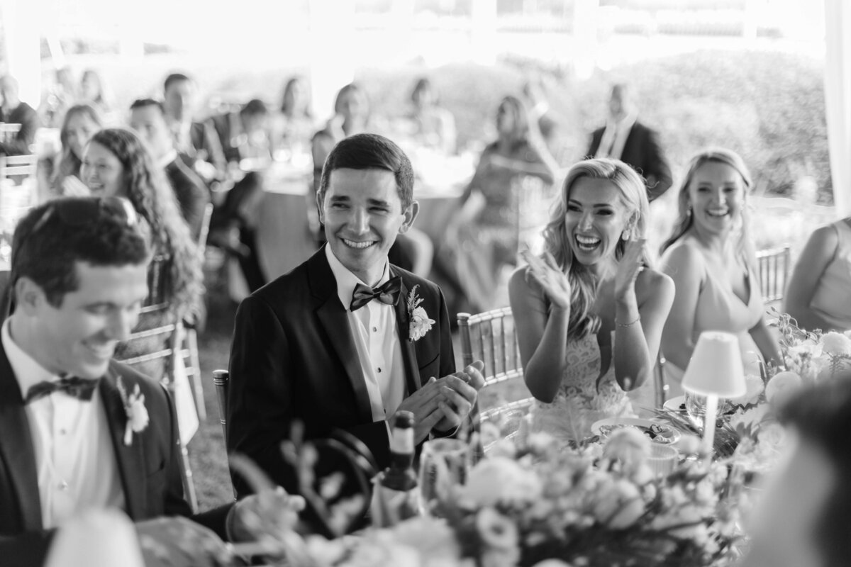 A groom and bride laugh.