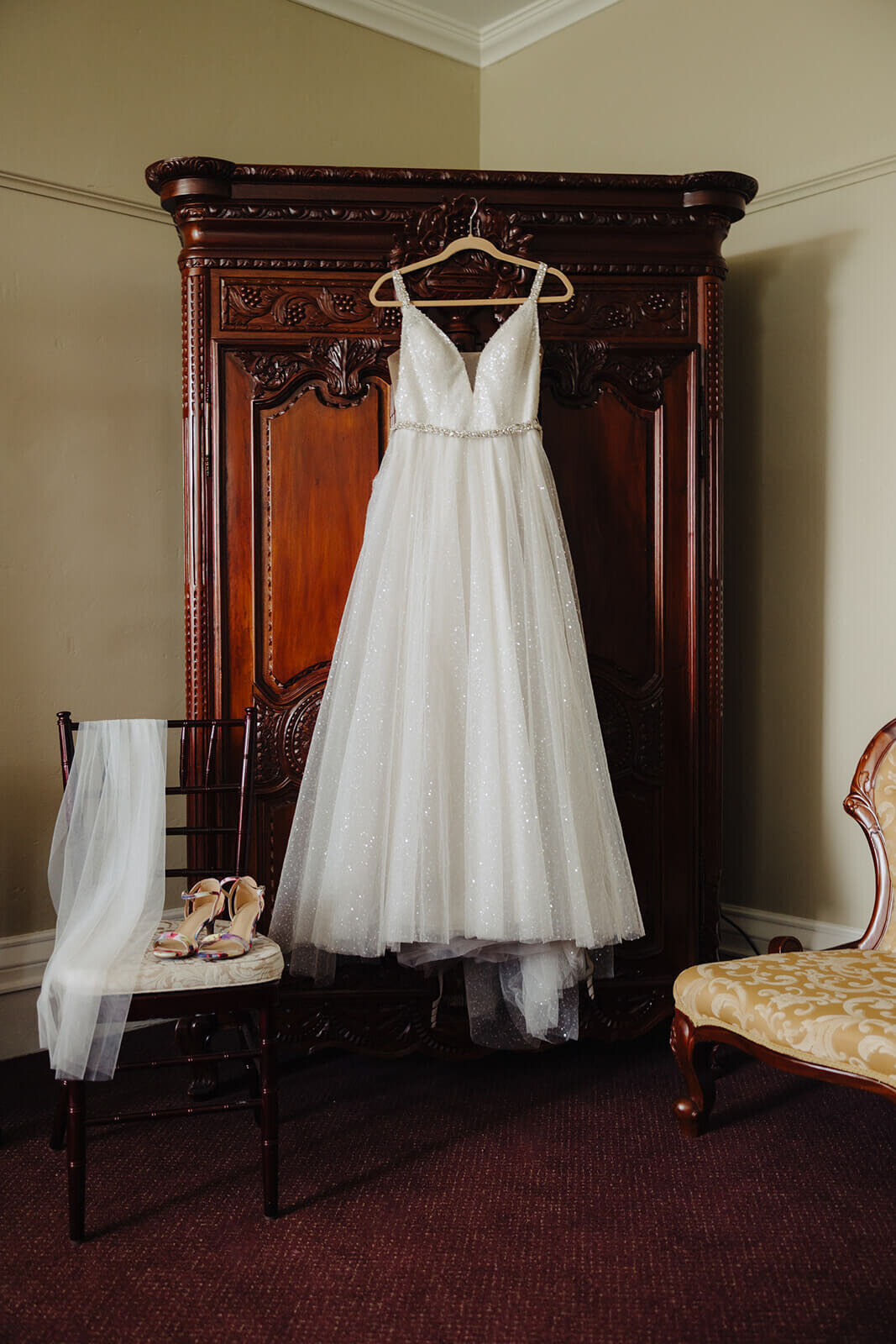 Brides dress hanging up for wedding at Mansion at Keuka Lake, NY