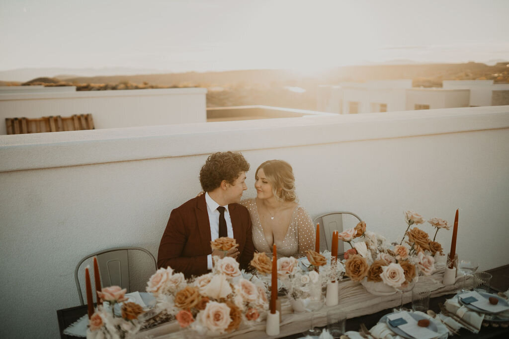 Couple share a meal together on a rooftop after Zion elopement