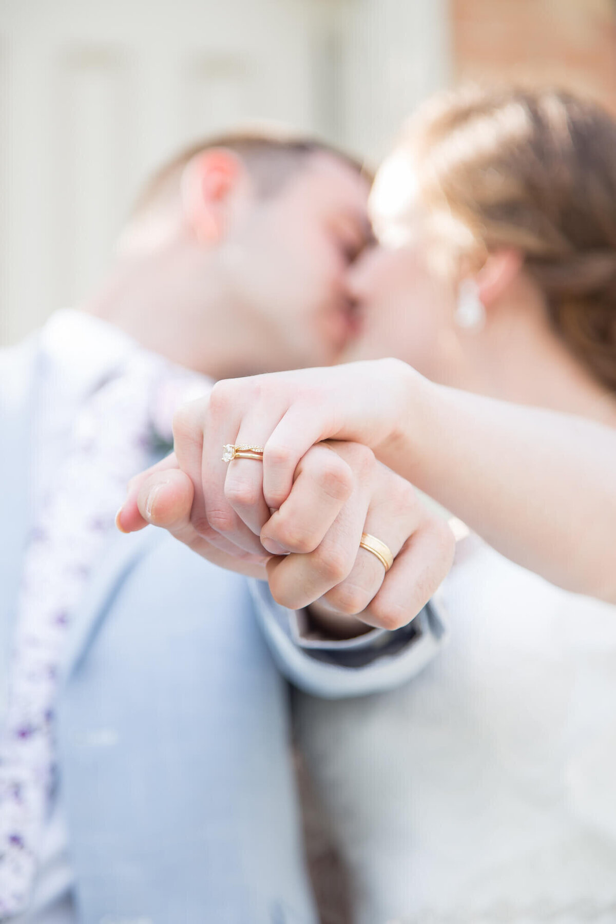 a wedding couple holding their hands out to show their rings