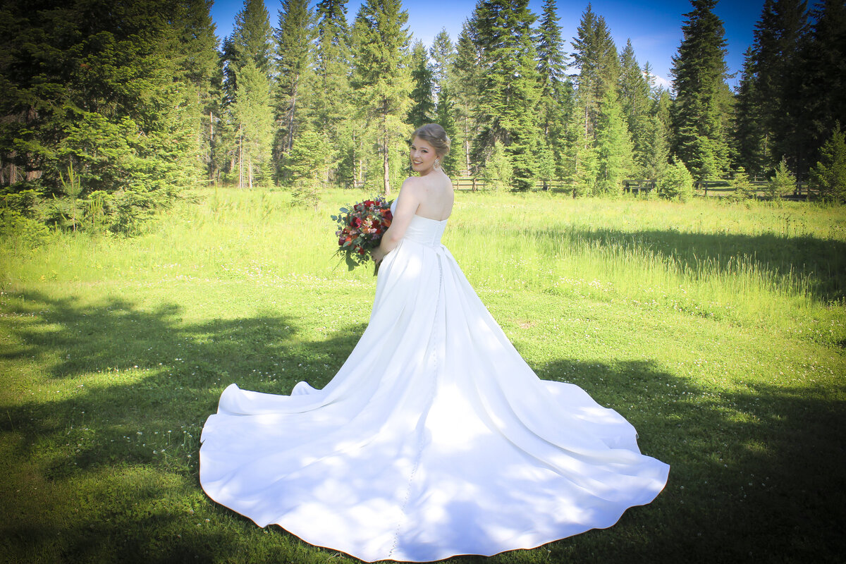 Back of brides dress in a meadow