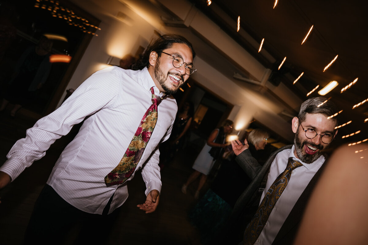 Friends dancing together at indoor wedding party