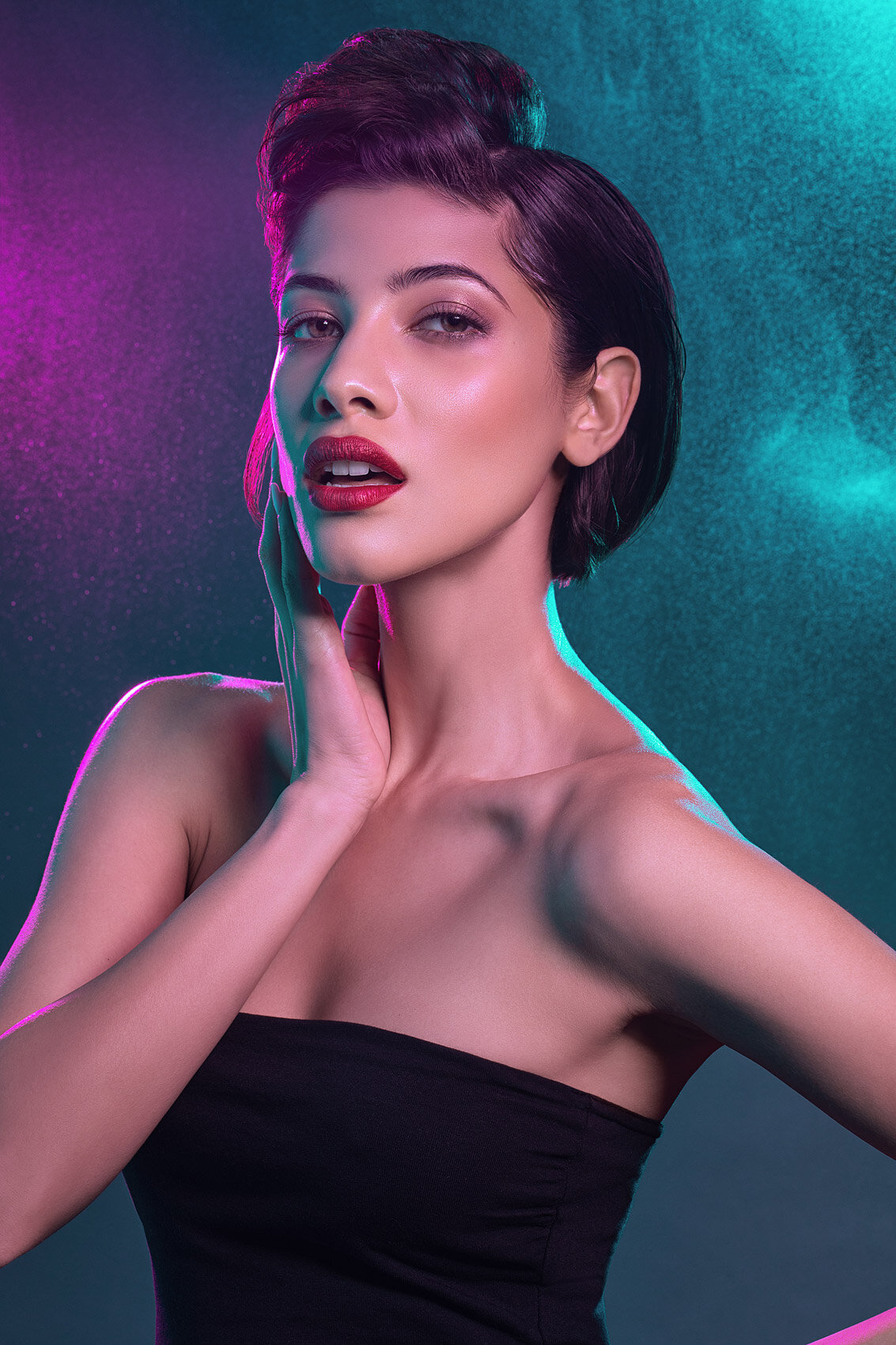 Glamorous studio portrait of Liz, featuring vibrant makeup and a striking pose by Ylva Erevall.