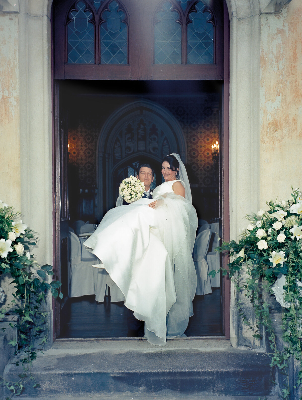 Joyful Bride and Groom Embraced in Elegance and Love, Capturing the Timeless Moment of Rice Throwing Ceremony