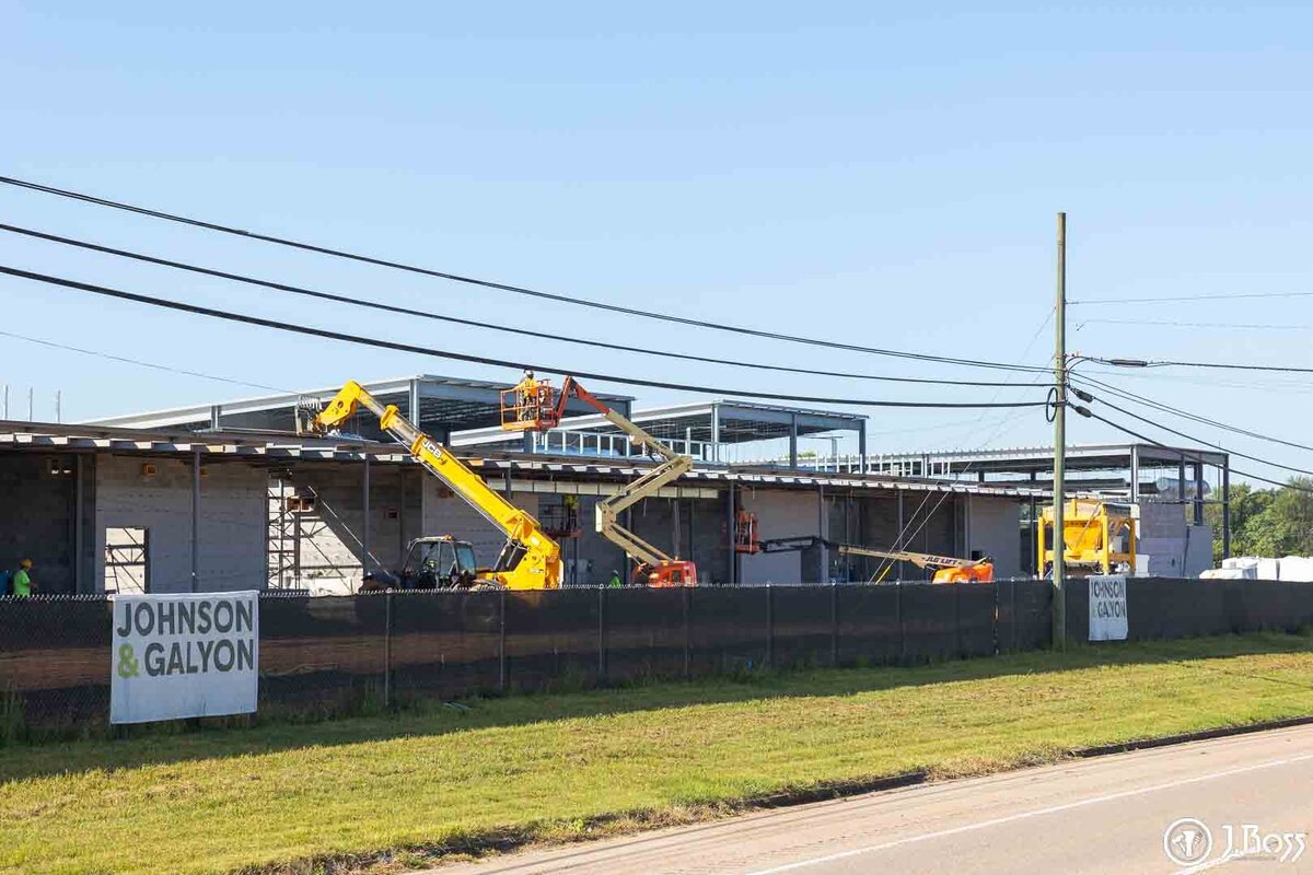 The exterior of the new Tennessee College of Applied Technology building in Greeneville, TN, featuring large HVAC ductwork and visible steel framing during the J.Ross Painting & Drywall commercial project.