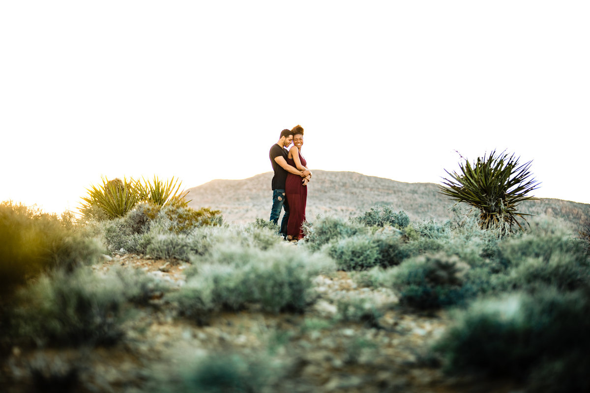 a photo of a couple running through the countryside at Jorgensen Farms