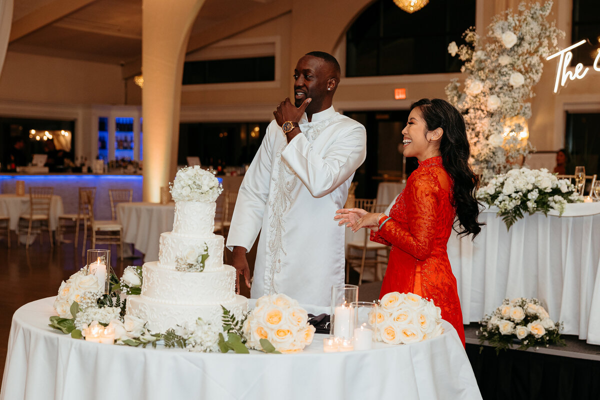 Bride wearing a red qipao. Groom wearing a white Tang suit. At the reception