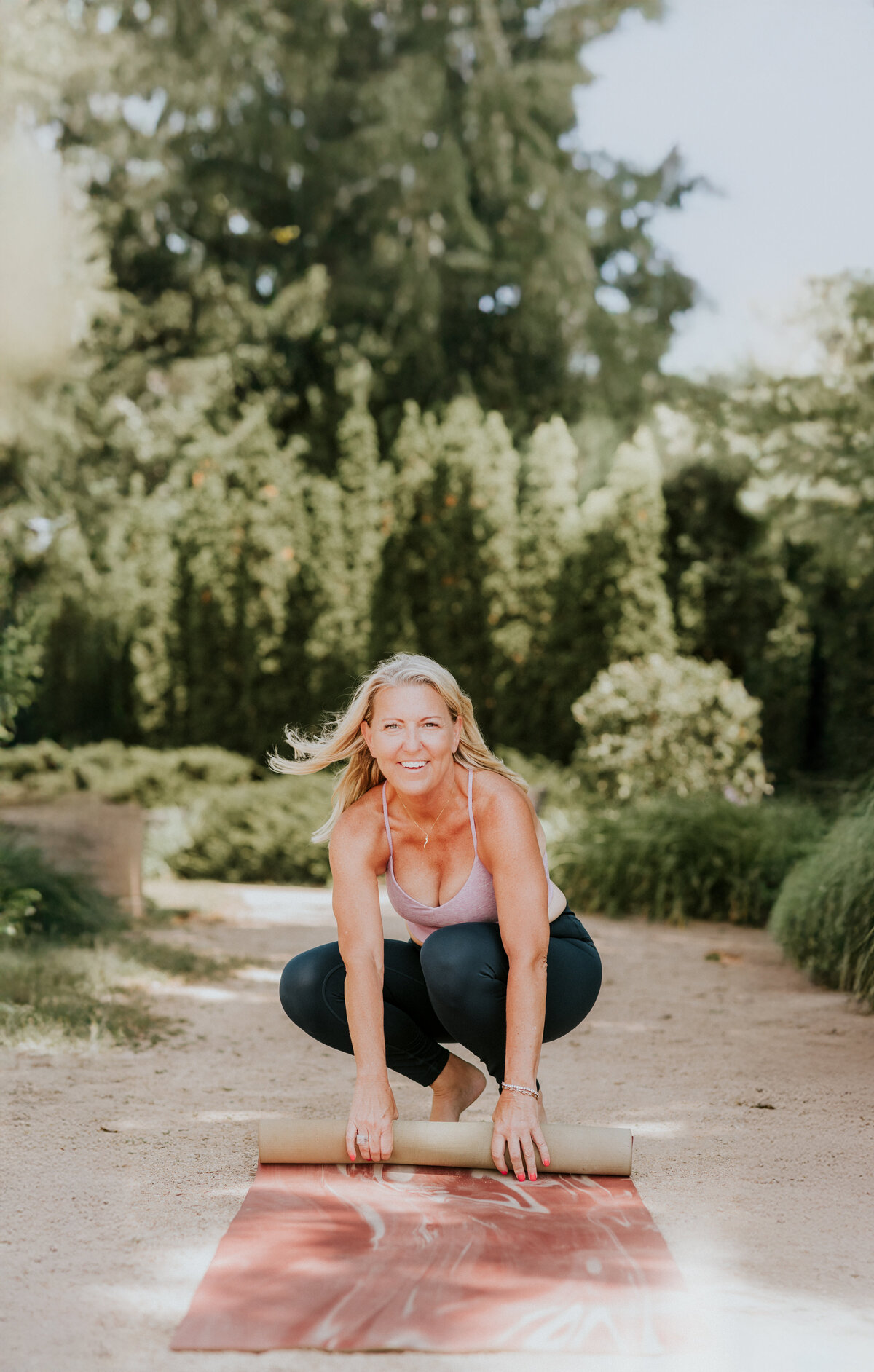 Amy Witte smiling during a yoga branding photoshoot at Summit Lookout Park in St. Paul for Inhale/Exhale Yoga.