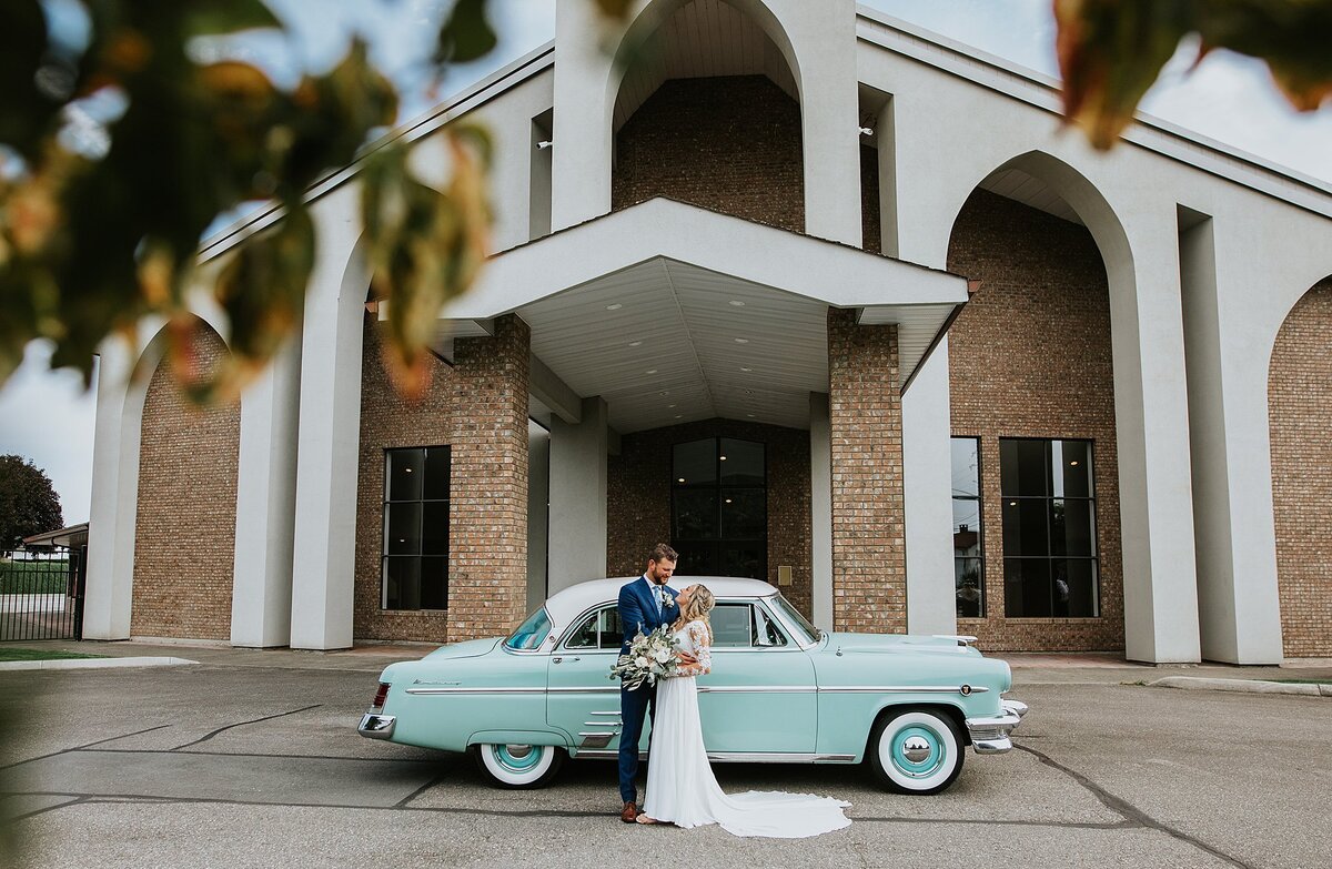 Bridal Couple in front of church and antique car