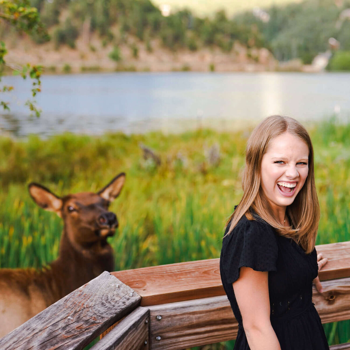 denver photography senior pictures - girl laughing and standing by deer
