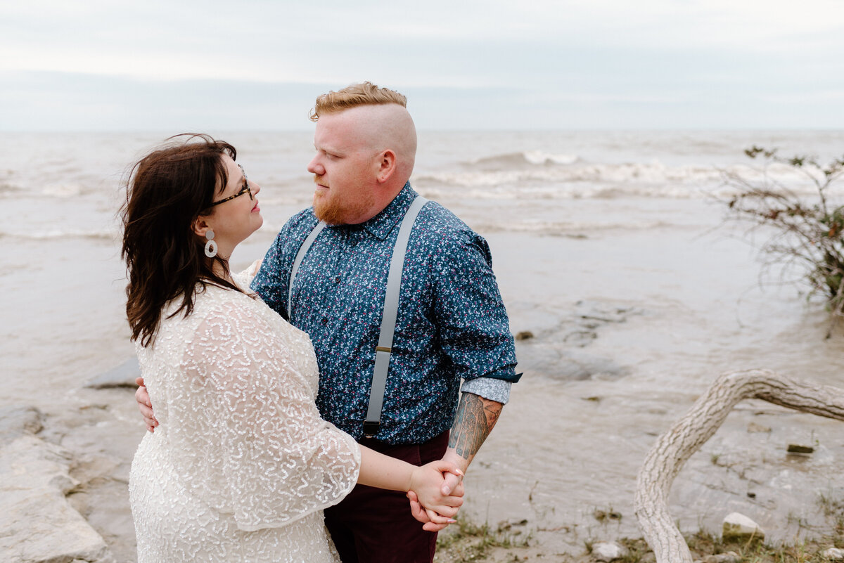 lake erie elopement bride and groom dance on the shore of lake erie
