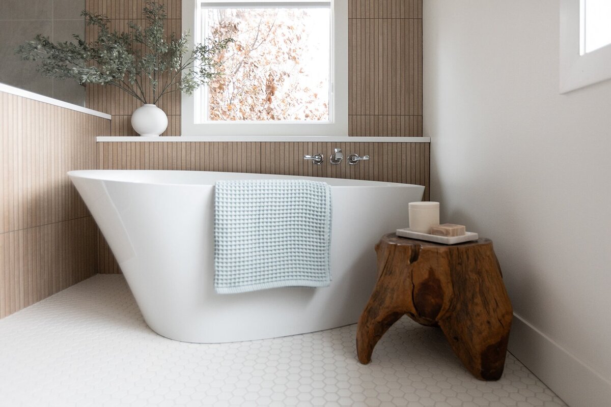 michele rosenboom design clean country renovation bathtub with light blue towel and wood slatted wall