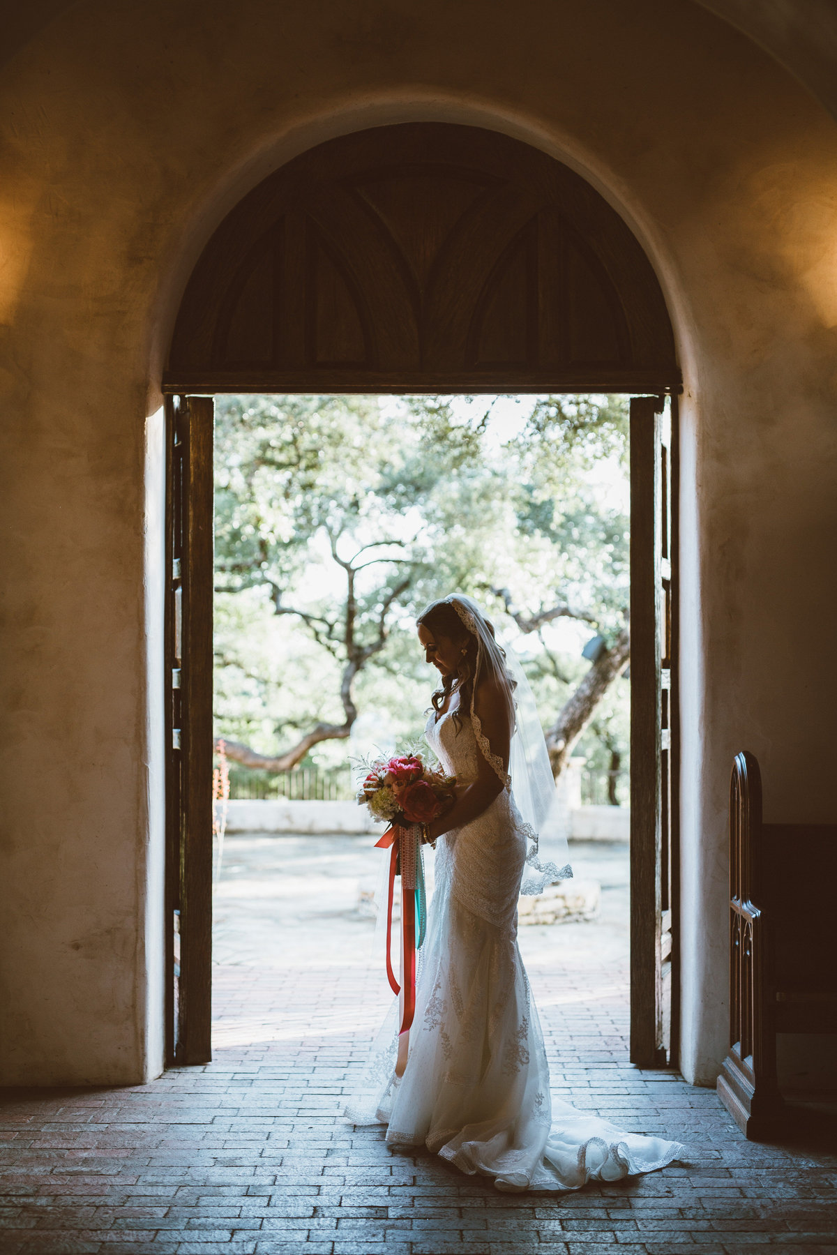 Bride standing in doorway at Lost Mission wedding venue after the wedding ceremony.