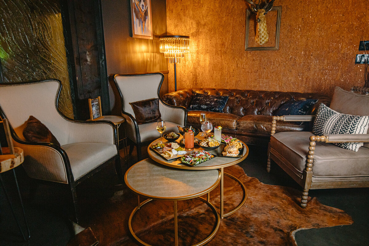 An array of food sits on a table in a wine cellar at the Windsor Mill Tavern in Windsor, Colorado