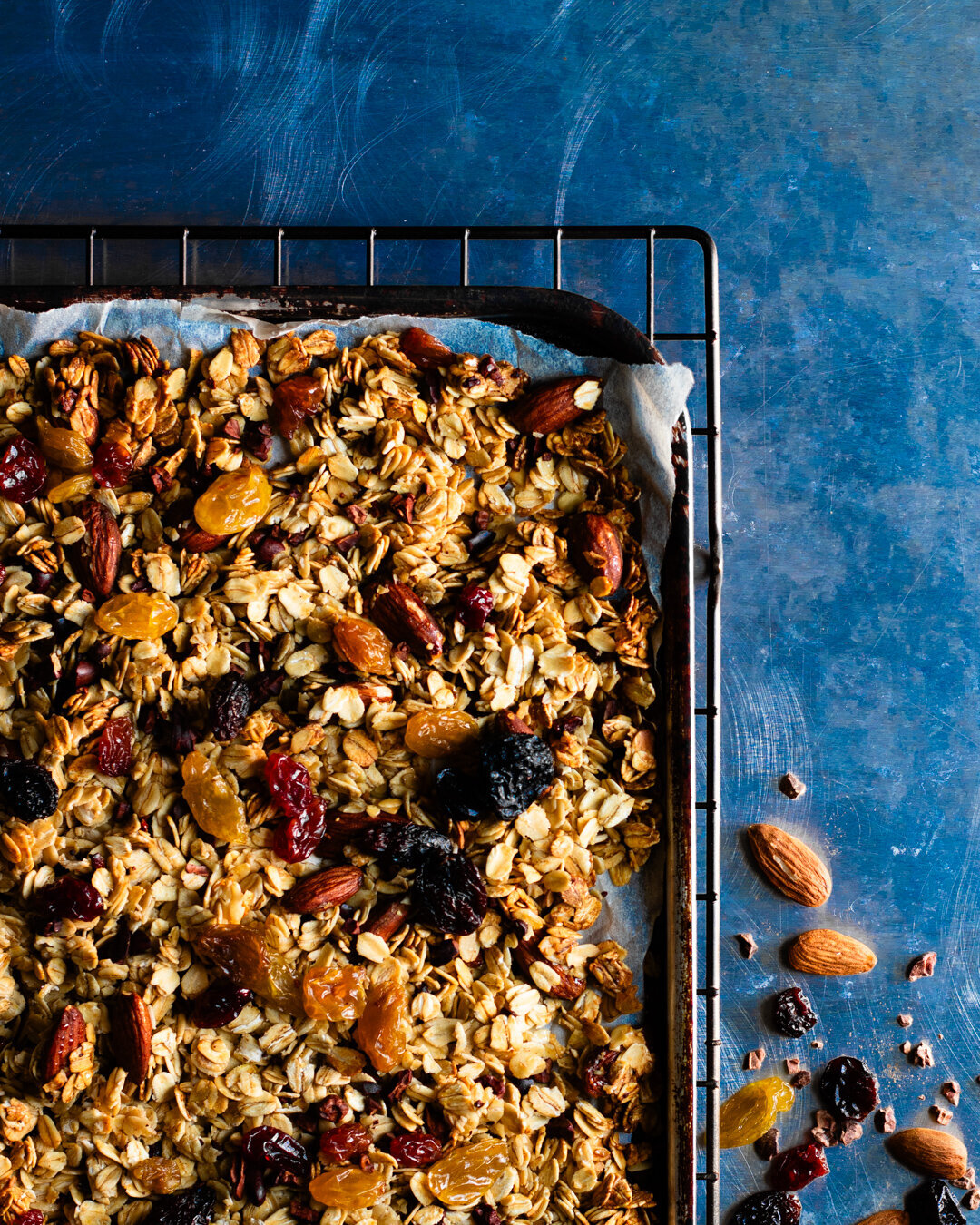 Tray of baked granola with almonds, honey and flame raisins