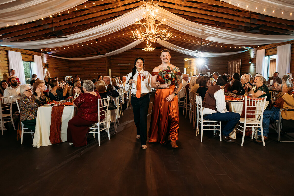 Wedding party makes a funny grand entrance with swapped outfits during reception at Plantation Oaks in Callahan, FL.