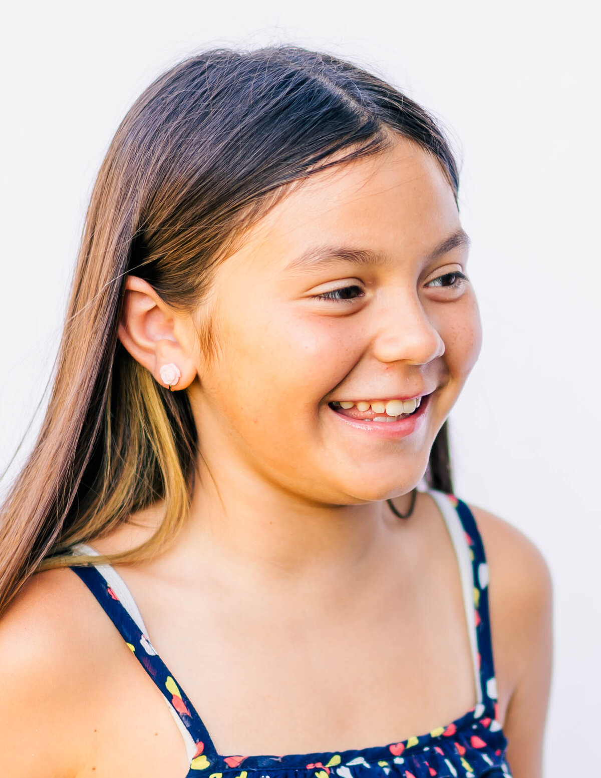 Portrait of preteen girl with confident expression, clean white background