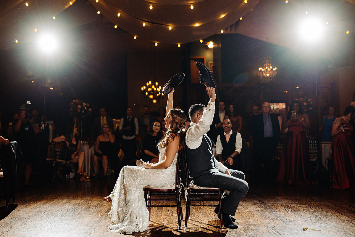 Bride and groom play the shoe game at their wedding reception,