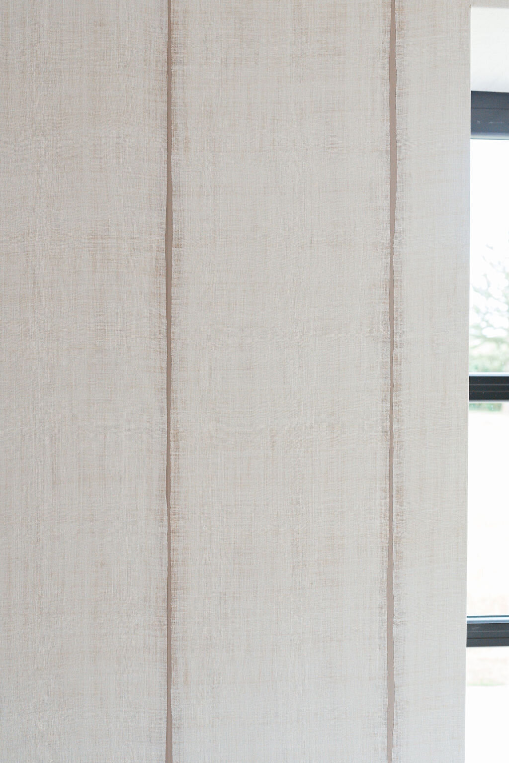 Close-up view of the neutral textured wallpaper in the dining space.