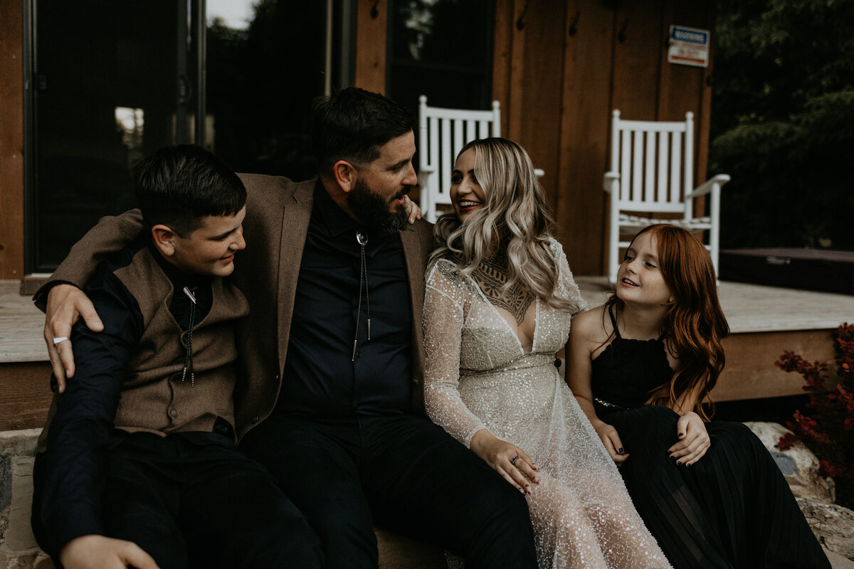 bride and groomj with their kids on a porch