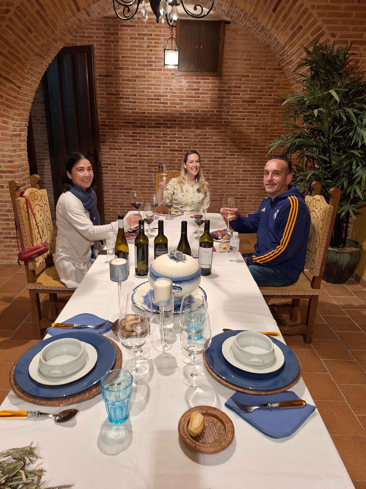 Maria Cristina and a couple sitting down for lunch at the Winery Lunch Experience.
