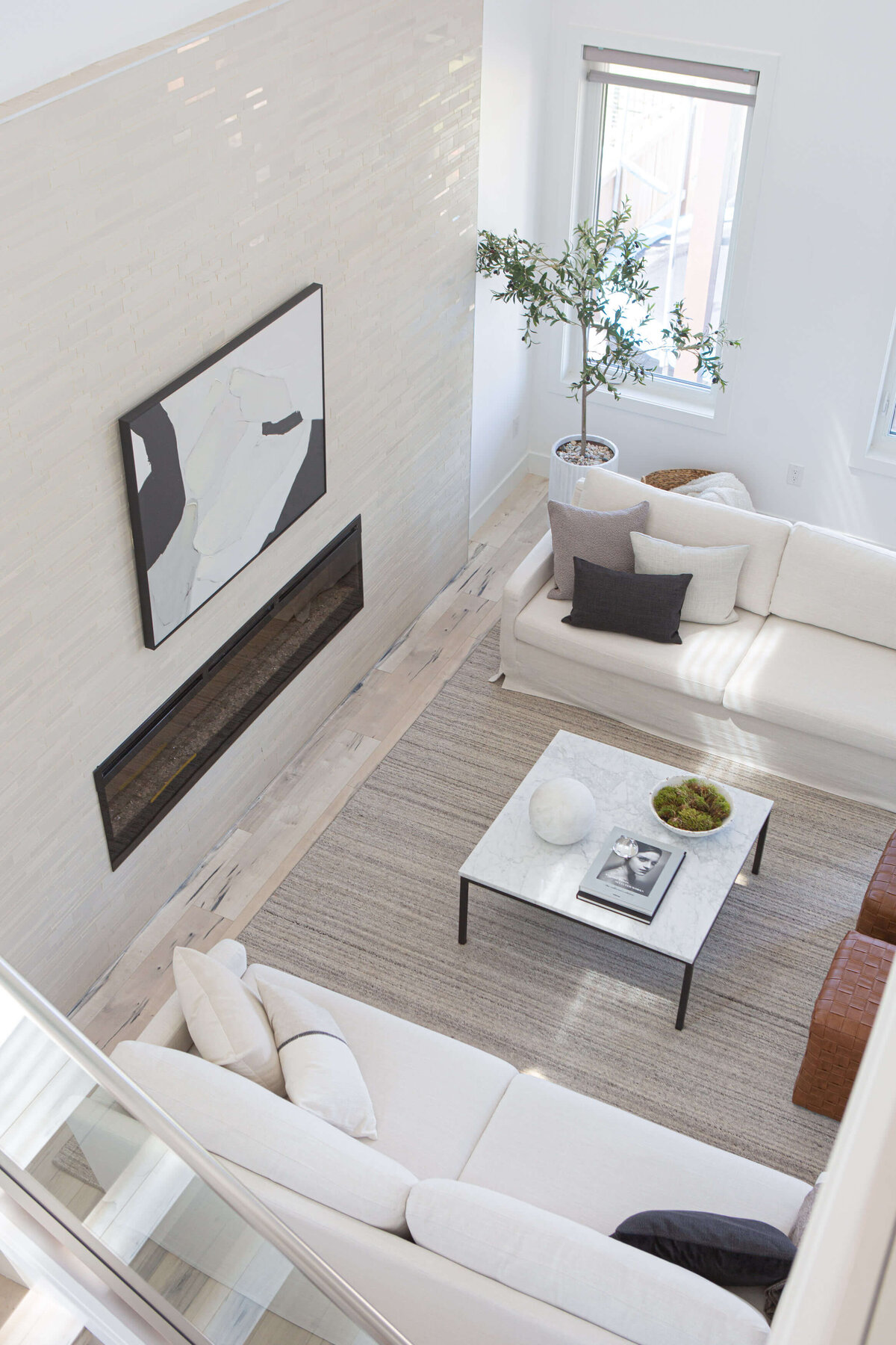 view of luxury show home living room viewed from above marble coffee table white sofas